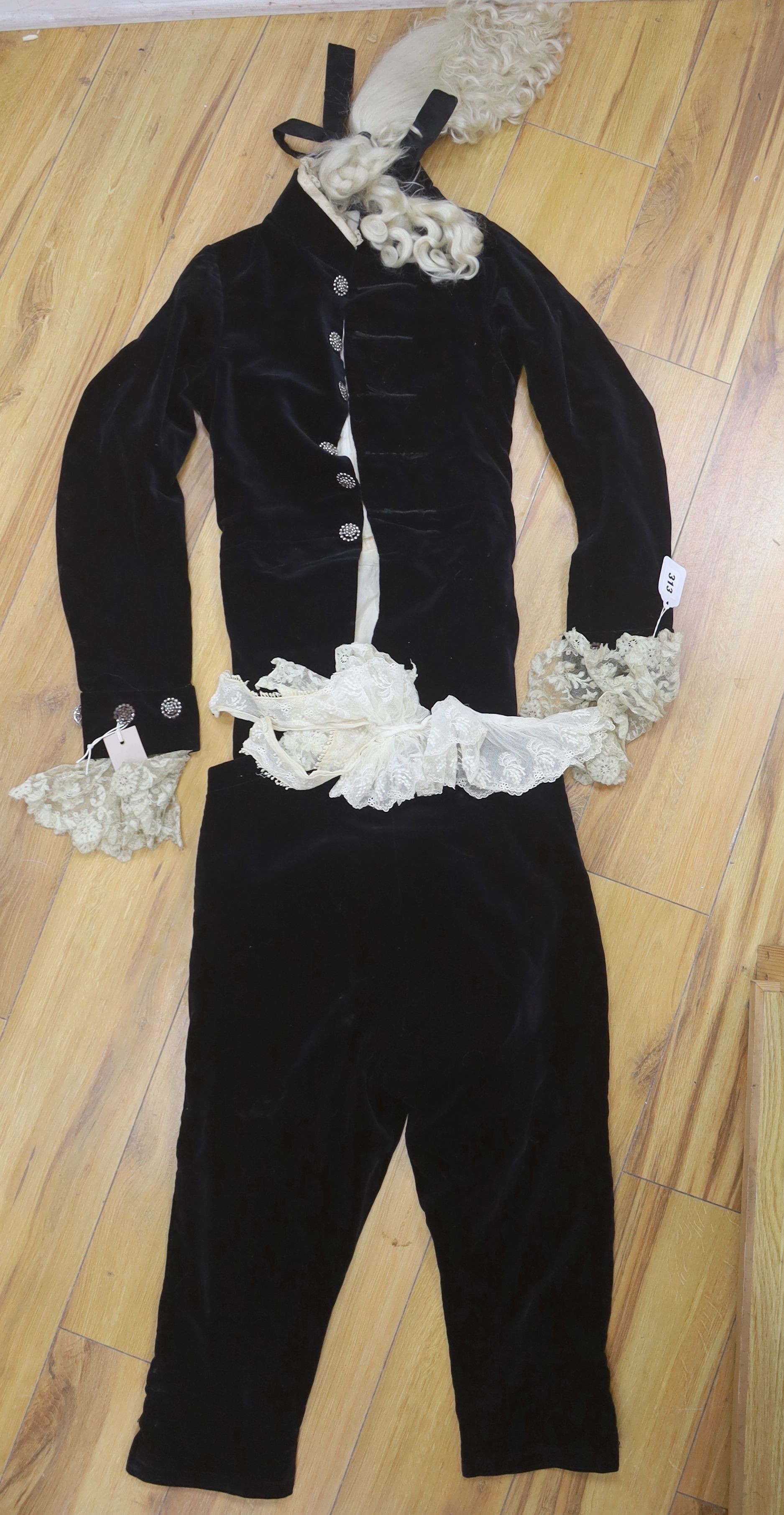 A 19th century black velvet page boys outfit with wig and lace collar, jacket - 84cm